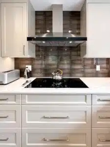 A kitchen with white cabinets and a stove

Description automatically generated